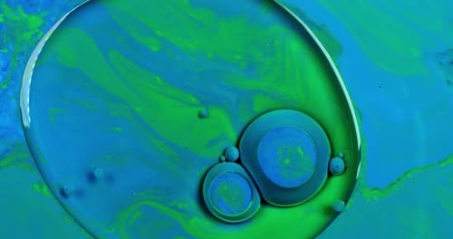 Blue bubbles swirling in liquid paint