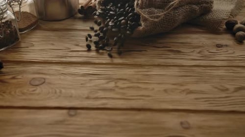 Roasted Coffee Beans Spill onto Rustic Wooden Table