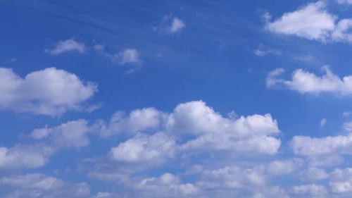 Clouds Moving Slowly Across a Blue Sky