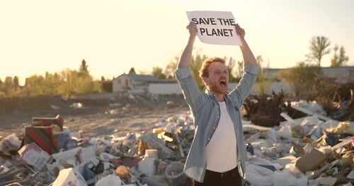 Young Man Protests in a Garbage Dump