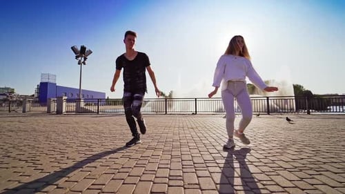 Young couple dancing in the city. Active couple dancing hip hop choreography