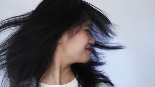Woman With Long Black Hair Tossing Head