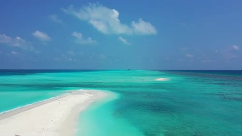 White sand sandbar in the middle of the endless turquoise sea. Sunny day with white fluffy clouds, M