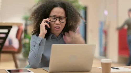 Angry Woman on Phone at Workplace