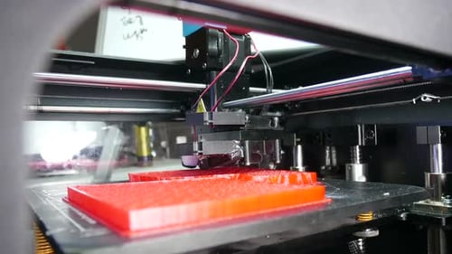 Close-Up of 3D Printer Creating Red Object