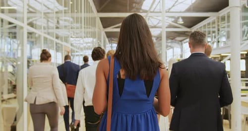 Professionals Walking in Bright Airy Business Space