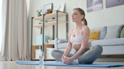 Woman Stretching on Exercise Mat in Her Home