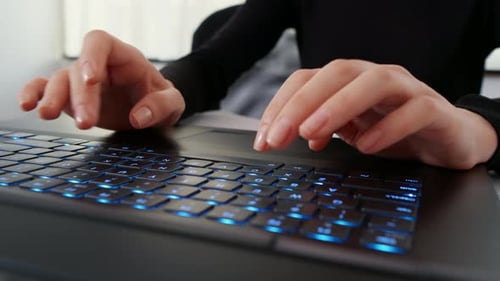 Close Up of Hands Typing on Laptop Keyboard