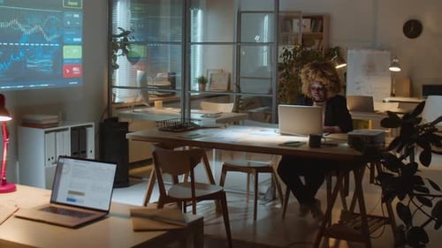 African American Businesswoman Working in Dark Office at Night