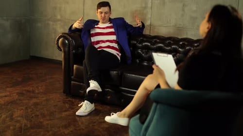 Young Man in Therapy Session Speaking to Therapist