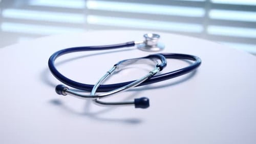 Stethoscope Lying on White Medical Table