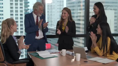 Business Team Applauding Success in Modern Office