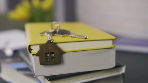 Keys and House Keychain on Books