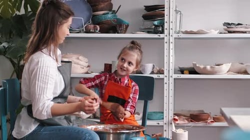 Woman and Child Creating Pottery in Studio