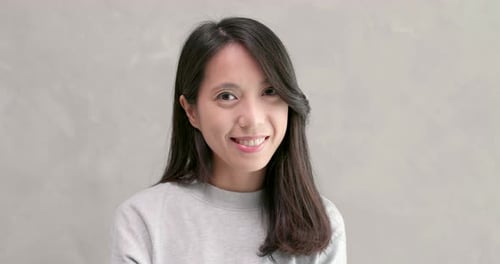 Smiling Young Woman in Gray Sweater Close-Up