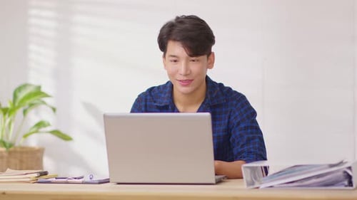 Young Man on Video Call Waving Hello