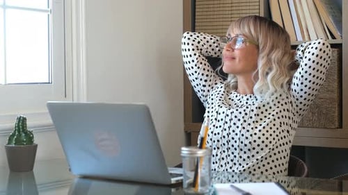 Adult woman have relax after work with laptop computer in home office - modern job smart working