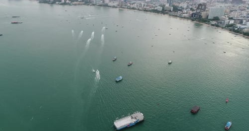 Aerial view of speed boats on the sea near beach city