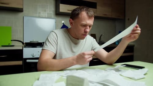 Man in shock, checks commodity checks, considers family budget