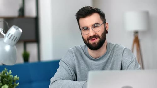 Smiling Man With Beard and Glasses in Home Setting
