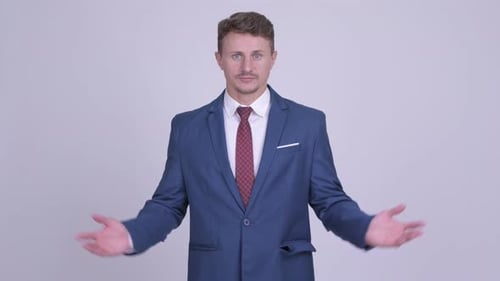 Serious Man in Suit Gesturing Questioningly