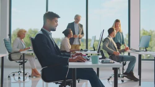 Modern Office with Adults Working at Computers