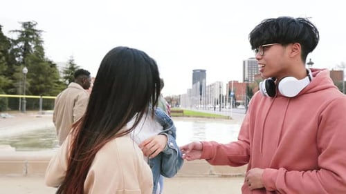 Group Of Three Multiethnic Teenage Students Standing Outside College Building Tlking Bout Homeworks