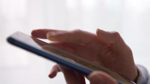 Close-up of a mobile phone in hands. Using a smartphone on social networks.