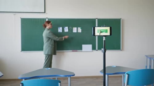 Teacher Giving a Lesson Recorded on a Smartphone