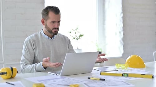 Young Architect Having Loss on Laptop in Office