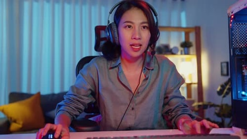 Woman Gamer Plays Computer Game at Night