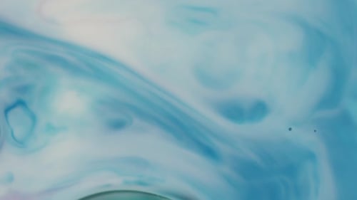 Abstract Turquoise and White Ink Flowing Together