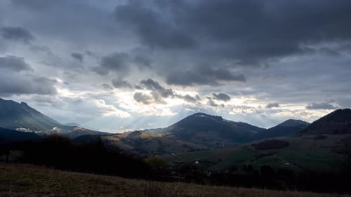 Dramatic Sunlight over Rolling Green Mountain Landscape
