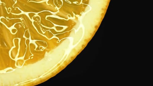 Sliced Orange Fruit with Drops of Juice Falling From It in Slow Motion. Closeup Macro Shot. Fresh