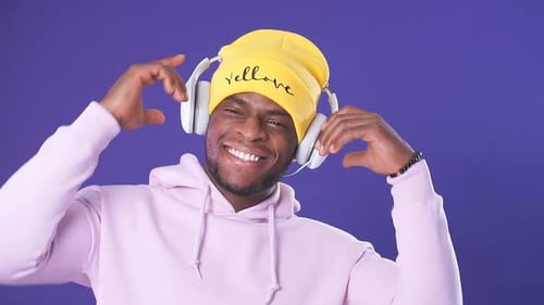 Happy Man with Headphones Smiling in Studio