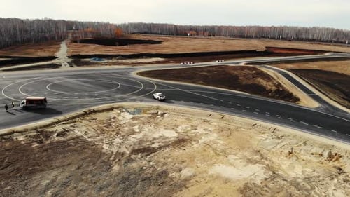Aerial View of White Pickup Truck That Drives and Turns Around at the Proving Ground