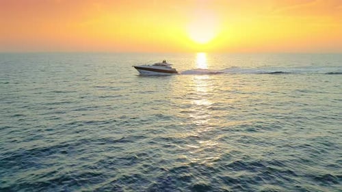 Speedboat Glides Across Ocean at Picturesque Sunrise