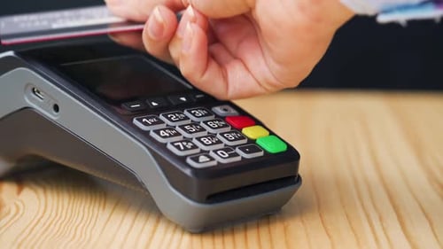 Close Up of Swiping Credit Card Through Reader