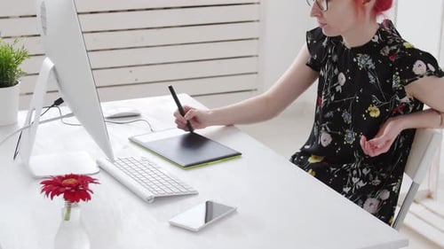 Woman Working on Graphics Tablet at Desk