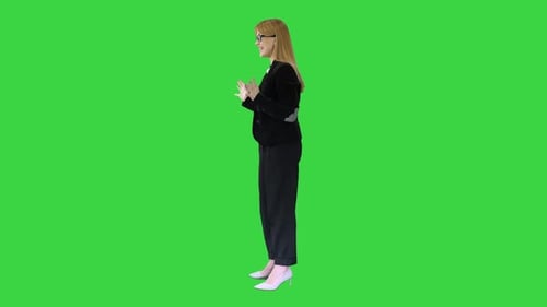 Smiling Businesswoman Explaining Something Emotionaly on a Green Screen, Chroma Key.
