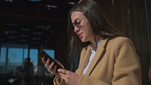 Young Woman Using Smartphone Outdoors in City