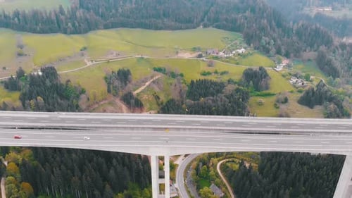 Aerial View of the Highway Viaduct on Concrete Pillars with Traffic in Mountains