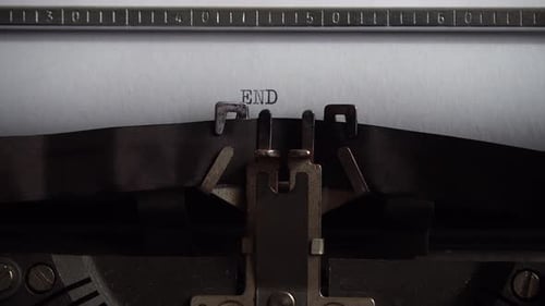 Typing word End on retro typewriter. Close up.