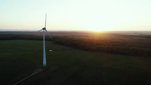 Wind Turbine Rotating in Golden Sunset Field