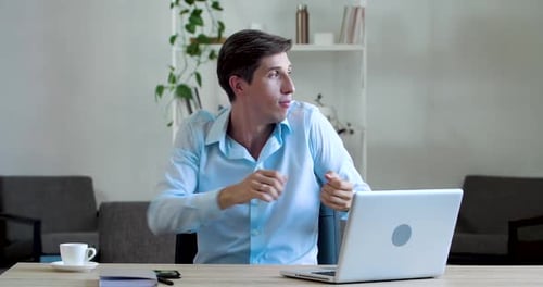 Active Funny Young Business Man Manager Doing Exercises in Office Sitting at Table, Actively Moving