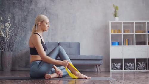 Woman Exercising with Resistance Band at Home