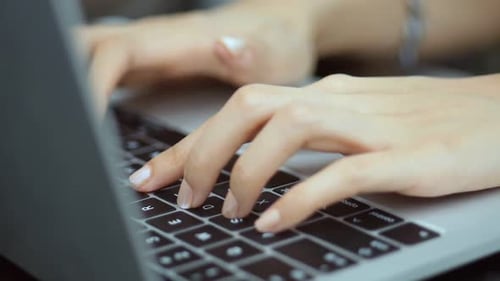 Woman Hands Typing on a Laptop Keyboard