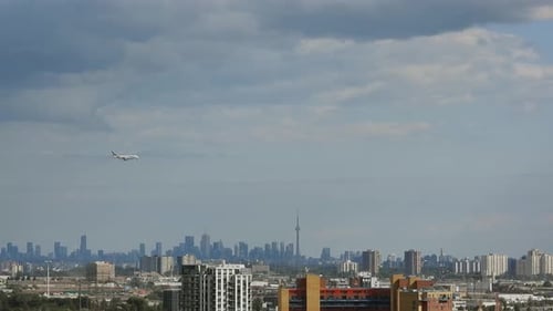 Aerial view of aeroplane landing in a blue sky over cityscape. Toronto. Canada