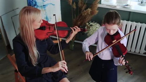 Violin Student Plays with Teacher in Art Studio