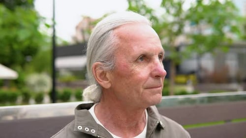 Lonely Stylish Elderly Man in Deep Thoughts Sitting on Park Bench